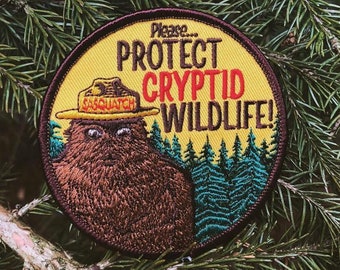 Cryptid PSA Patch - Cryptozoology Tracking Society Bigfoot Sasquatch Badge NPS Smokey the Bear Woodland Hiking Camping Fish Hunt