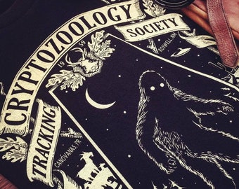 Cryptozoology Tracking Society Tee Black/Moon (Unisex/Mens) Glow in the Dark Sasquatch Bigfoot T-shirt National Parks Treasure