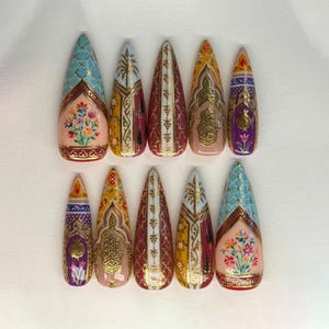 May include: A white ceramic mug with a black handle and the text "But First, Coffee" in a black, handwritten-style font. The mug is on a white surface.