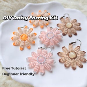 May include: DIY daisy earring kit with multiple handmade daisy earrings in shades of orange, pink, and tan. The earrings are arranged on a white plate. Text on the image reads "DIY Daisy Earring Kit", "Free Tutorial", and "Beginner friendly".