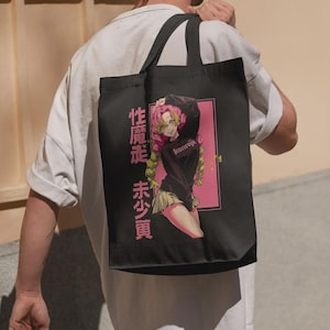 May include: Black tote bag featuring a pink and black anime graphic. The graphic includes a female anime character with pink hair and the text "kanroji". Japanese text is also present on the bag.