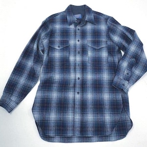 May include: A long-sleeve button-down shirt featuring a plaid pattern in shades of navy blue, light blue, and white. The shirt includes a standard collar, a front button placket, and two chest pockets with buttoned flaps on each side of the front.