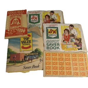 Puede incluir: Una colección de libros y hojas de ahorro de sellos antiguos. Los libros presentan gráficos y texto coloridos, incluyendo "Gold Bell", "Green Stamps" y "Top Value Stamps". La imagen también incluye una hoja de sellos naranjas con un diseño.