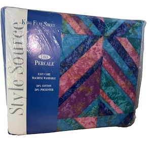 May include: A packaged King flat sheet with a geometric design in blue, teal, pink, and purple. The packaging features the text "Style Source", "180 Percale", and "Easy Care Machine Washable". The sheet is made of 50% cotton and 50% polyester.