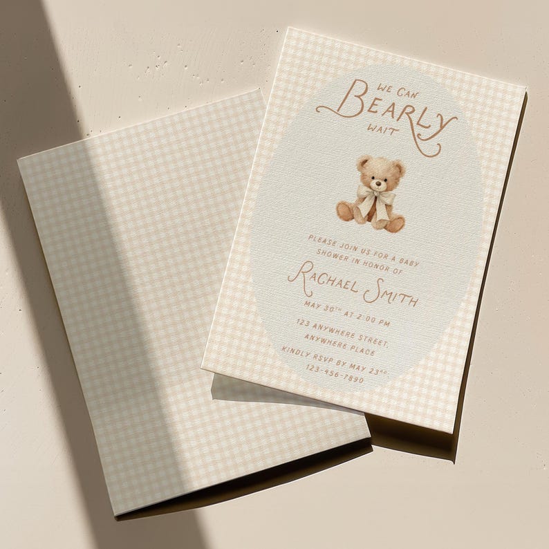 May include: A rectangular baby shower invitation card with a light beige gingham pattern. The center features an oval area with a brown teddy bear illustration wearing a white bow, and text reading We Can Bearly Wait, Please Join Us For A Baby Shower In Honor Of Rachael Smith, May 30th At 2:00 PM, 123 Anywhere Street, Anywhere Place, Kindly RSVP By May 23rd, 123-456-7890.
