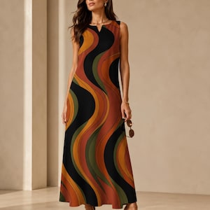 May include: A sleeveless maxi dress featuring a bold, wavy pattern in shades of black, burnt orange, olive green, and mustard yellow. The dress has a straight silhouette, a round neckline with a small centre slit, and falls to the ankles.