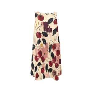 A flat lay of the front of a sleeveless cream A-line mini dress with a red and black cherry print.