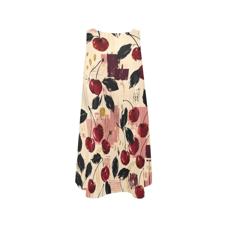 A flat lay of the front of a sleeveless cream A-line mini dress with a red and black cherry print.