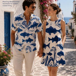 A man and woman walk hand-in-hand down a narrow street; the woman wears a fish-print dress, and the man wears a matching fish-print shirt.
