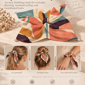May include: A square hair accessory featuring a multi-coloured abstract pattern in shades of coral, teal, cream, and dark purple. The fabric has a smooth satin finish and is accented with small white faux pearls at each corner. It measures 26 x 26 cm.