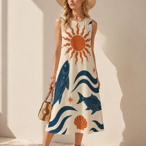 May include: A sleeveless midi dress in cream featuring a large orange sun graphic, dark blue fish illustrations, wavy blue lines, and an orange seashell print. The dress has a round neckline and a loose, straight silhouette that falls below the knees.