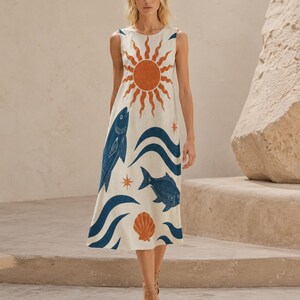 May include: A sleeveless midi dress in an off-white fabric featuring a large orange sun graphic at the chest, blue fish illustrations, blue wave patterns, orange seashell motifs, and small orange star accents distributed across the garment.