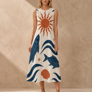 May include: A sleeveless midi dress in off-white featuring a large rust-colored sun graphic at the neckline, dark blue fish illustrations, stylized blue waves, and a rust-colored seashell print scattered across the fabric with small star accents.