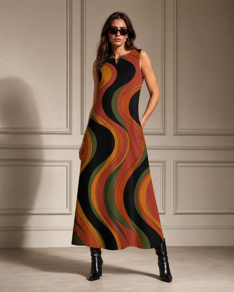 May include: A sleeveless floor-length maxi dress featuring a bold, wavy, multi-coloured pattern in shades of black, burnt orange, mustard yellow, and olive green. The dress has a simple round neckline with a small centre slit and a straight silhouette.