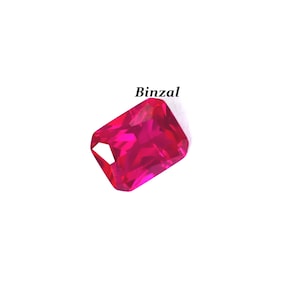 May include: A vibrant, rectangular-cut, fuchsia gemstone with a faceted surface. The gem is set against a white background, with the word "Binzal" in black text above it. The gem's color is a deep, saturated pink.