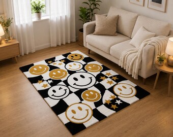 May include: A rectangular area rug featuring a black and white checkered pattern overlaid with various yellow smiley faces and small gold stars. The design includes multiple expressions, including winking and smiling faces, distributed across the surface.