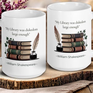 May include: White ceramic mugs with the quote "My Library was dukedom large enough" and a quill, inkwell, and stack of books design. The quote is attributed to William Shakespeare.