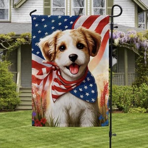 May include: A garden flag featuring a smiling dog wearing a patriotic bandana with the American flag in the background. The flag has a black pole and is displayed on a green lawn in front of a house.