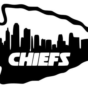 May include: Black and white graphic of a cityscape silhouette inside an arrowhead shape. The word "CHIEFS" is displayed in bold white letters below the skyline. The design is a logo for a sports team.