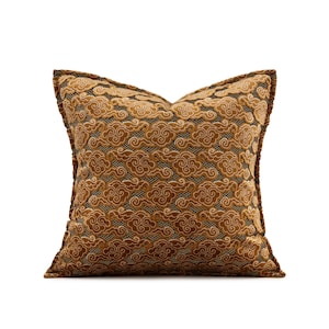 May include: Square decorative pillow with a cloud pattern in shades of brown, tan, and black. The pillow has a textured surface and a contrasting brown border. The cloud design is repeated across the entire pillow.
