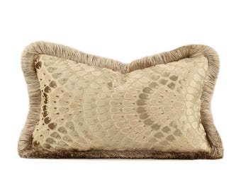 May include: A rectangular decorative pillow with a beige snakeskin pattern. The pillow has a fringe border in a matching beige color. The pillow is designed for home decor and adds a touch of elegance to any space.