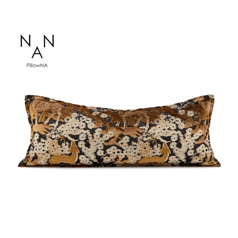May include: Long rectangular cushion featuring a deer and floral design in brown and gold tones. The pattern is set against a black background with white floral details. The brand name "PillowNA" is printed in black.