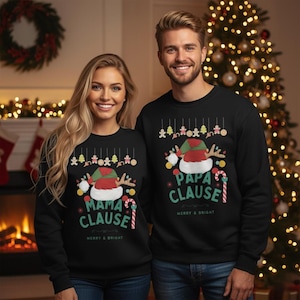 May include: Matching black sweatshirts with Christmas-themed designs. One says "Mama Clause" and the other says "Papa Clause" in white and red lettering. Each features a Santa hat, reindeer antlers, and candy canes. "Merry & Bright" is printed below.