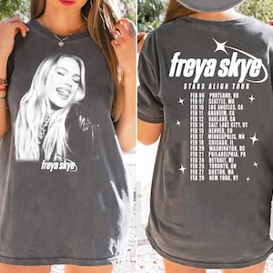 May include: Dark grey t-shirt with a black and white image of Freya Skye. The front displays the artist's name. The back of the shirt lists tour dates and locations for the "Stars Align Tour".
