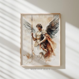 Puede incluir: Impresión en acuarela de un ángel con grandes alas, sosteniendo una lanza. El ángel lleva una armadura dorada y una capa roja. La obra de arte está enmarcada en un marco de madera clara. El texto "WORSHIP HAUS" está en la parte inferior.