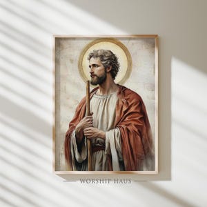 May include: A framed print featuring a portrait of a man with a beard, holding a staff. The man is wearing a red robe and a white tunic, with a gold halo behind his head. The text "WORSHIP HAUS" is printed at the bottom of the frame.