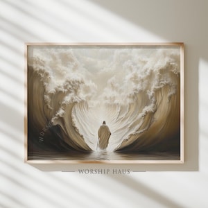 Puede incluir: Una impresión enmarcada que representa una figura con una túnica que camina a través de aguas separadas, con grandes olas a ambos lados. La obra de arte está en tonos apagados de beige y marrón, con el texto "WORSHIP HAUS" en la parte inferior.