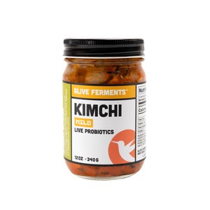May include: A jar of kimchi with a black lid. The label reads "Alive Ferments" and "Kimchi Mild Live Probiotics". The jar contains a reddish-orange fermented food product. The jar is 12oz or 340g.