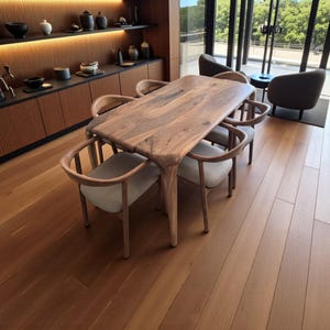 May include: A wooden dining table with an unusual, organic form, encircled by six chairs with curved wooden frames and light-coloured upholstered seats. The table and chairs are set on a hardwood floor, creating a warm dining area.