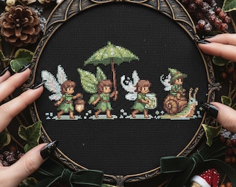 May include: Cross-stitch artwork depicting four fairies in green attire, with wings, carrying a lantern, umbrella, and a jar. One fairy rides a snail. The piece is framed in a decorative, dark-toned frame.