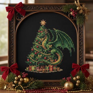 May include: Cross-stitch art featuring a Christmas tree with a dragon wrapped around it, adorned with ornaments and gifts. The artwork is framed in a dark wooden frame with red bows and festive greenery. The dragon is green and gold.