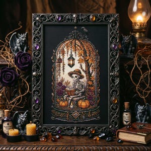 May include: A framed cross-stitch featuring a skeleton reading a book under a tree with pumpkins and flowers. The frame is ornate with skulls and gems. The color palette includes black, orange, and purple, evoking a Halloween theme.