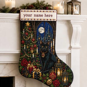Puede incluir: Un calcetín navideño negro con un diseño de punto de cruz de un gato negro, un árbol de Navidad decorado, regalos y linternas. El puño superior es blanco con el texto 'your name here' en granate, bordeado por patrones de punto de cruz.