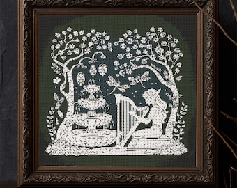 May include: Cross-stitch artwork in a dark brown frame. The image shows a tranquil scene with a fountain, trees, and a figure playing a harp. The design is in white against a dark green background, creating a striking contrast. The frame has an ornate, detailed design.