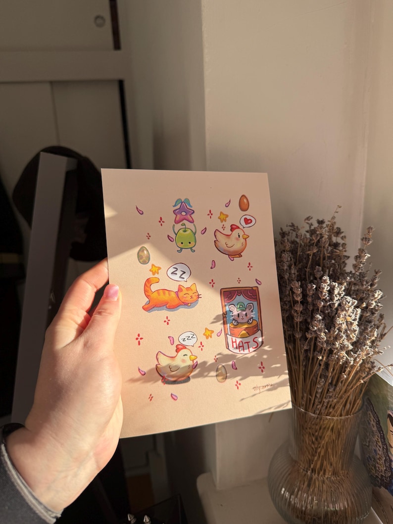 May include: A whimsical illustration featuring cartoon animals and objects. The artwork includes a sleeping orange cat, a chicken, and a mouse in a box labeled "HATS." Decorative elements like eggs, stars, and flowers are scattered around the characters.