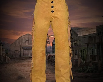 May include: Mustard-colored suede pants with three black buttons and fringe detailing along the sides. The pants have a classic western style, perfect for a costume or themed event.
