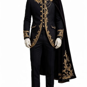 May include: Black formal suit with gold embroidered detailing, including a jacket with ornate patterns, gold buttons, and matching pants. A black cape with gold embroidery is draped over the shoulder. The suit is displayed on a mannequin.