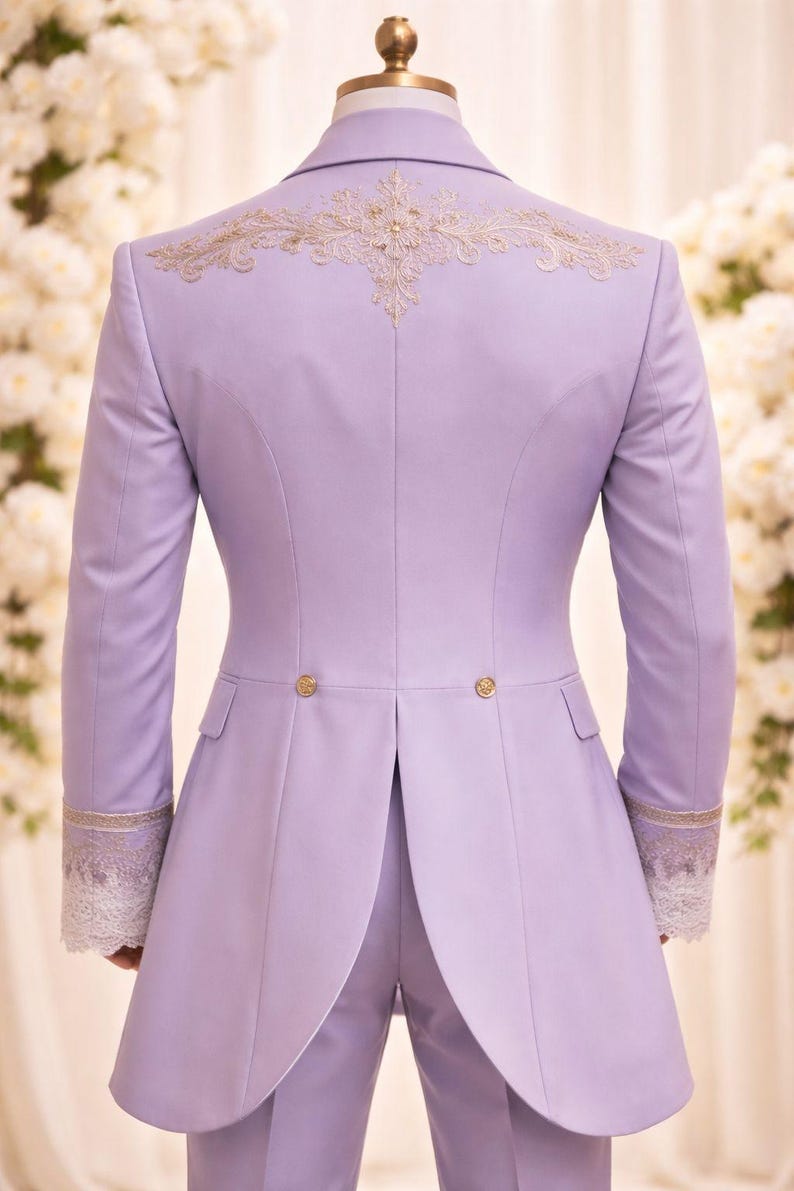 May include: A light purple suit jacket with gold embroidery on the back and cuffs. The jacket has a long, tailored design with gold buttons and a split tail. The cuffs feature white lace detailing.