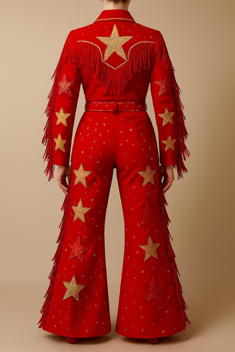 May include: Red jumpsuit with gold star embellishments and fringe detailing. The jacket features a large star design on the back and fringe along the sleeves. The pants are flared and also adorned with gold stars. A belt cinches the waist.