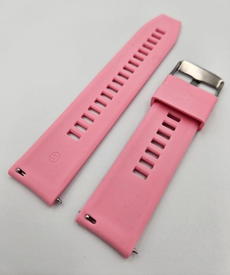 Detail of light pink (baby pink) silicone watch strap with stainless steel buckle, pastel unisex replacement band.