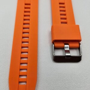 Bright orange silicone watch strap with stainless steel buckle and quick release spring bars, durable and sporty unisex replacement band.