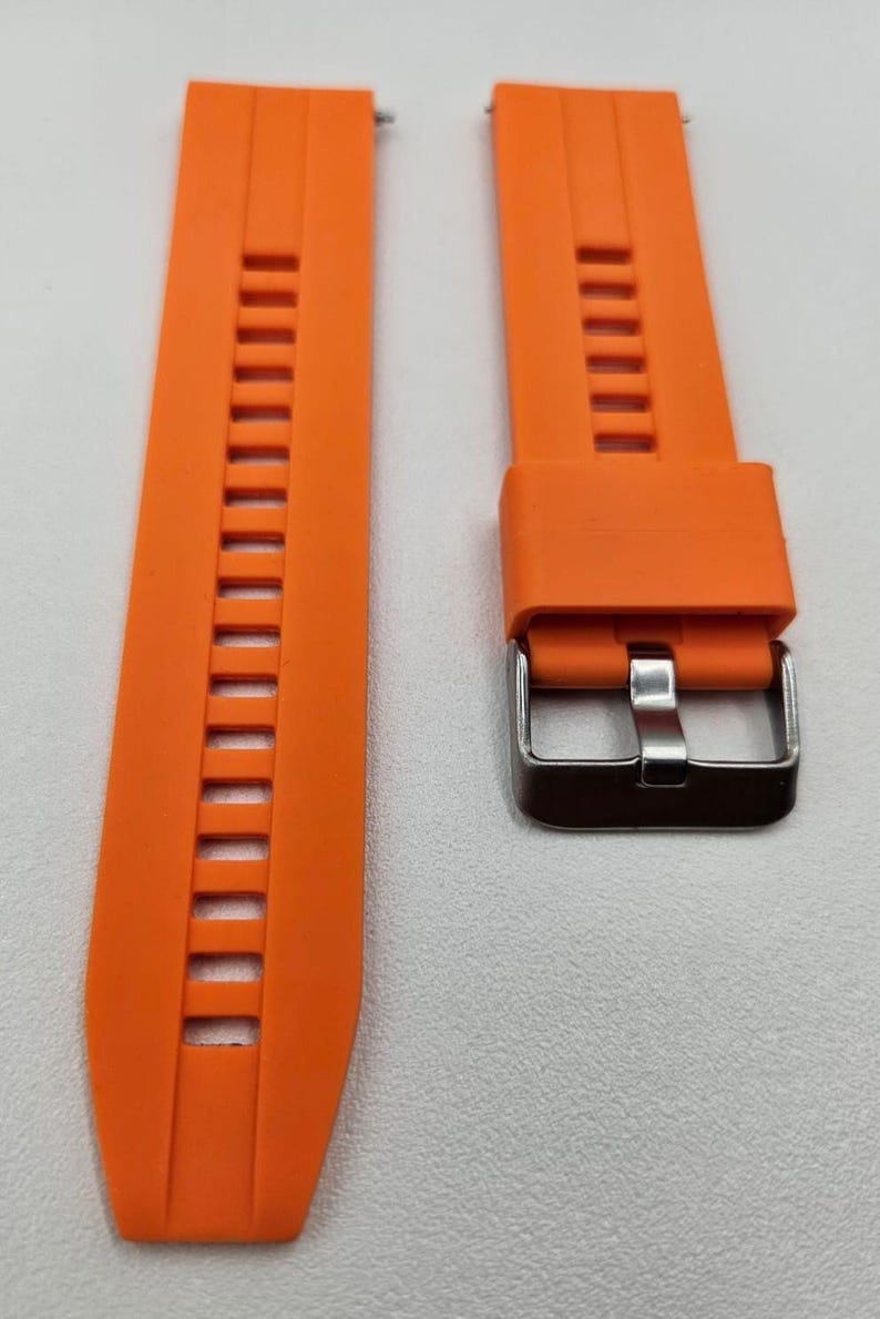 Bright orange silicone watch strap with stainless steel buckle and quick release spring bars, durable and sporty unisex replacement band.