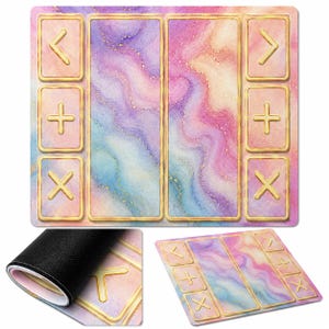 May include: A rectangular playmat featuring a marbled pattern in shades of pink, purple, and blue with gold accents. The surface includes two large central rectangular areas flanked by six smaller squares with gold-outlined symbols including arrows, plus signs, and multiplication signs.