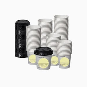 May include: A collection of white paper coffee cups and black lids. Some cups are stacked, others are assembled. The cups have a yellow label with the text "IS FEARFULLY AND WONDERFULLY MADE" and "Psalm 139:14".