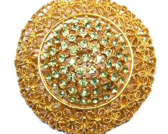 Vintage pale green peridot green rhinestone brooch with gold filigree flowers domed brooch