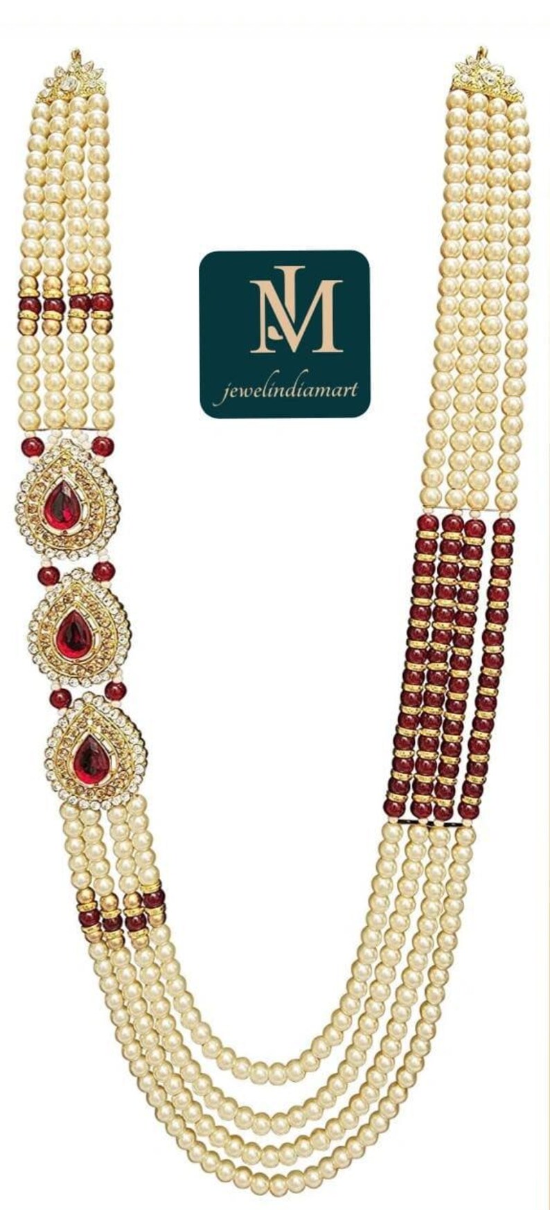 May include: A multi-strand necklace featuring faux pearls, red gemstones, and gold-toned accents. The necklace includes three ornate pendants with teardrop-shaped red stones. The logo "jewelindiamart" is visible.